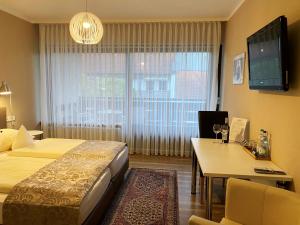 Postel nebo postele na pokoji v ubytování Hotel garni Bellevue