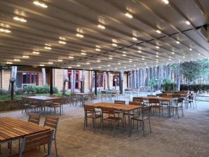 a group of tables and chairs in a patio at Jack Family Hotel in Stara Zagora