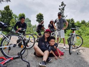 a group of people posing for a picture with their bikes at THE GINGKO EYRIE in Kalimpong