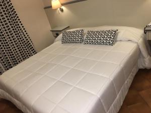 Postel nebo postele na pokoji v ubytování Hotel Ai Tufi