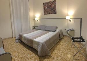 Postel nebo postele na pokoji v ubytování Hotel Ai Tufi