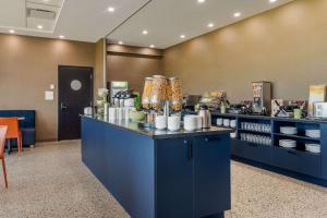 a restaurant with a blue counter with food at Quality Inn & Suites Mont-Joli in Mont-Joli