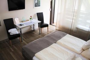 Postel nebo postele na pokoji v ubytování Hotel garni Bellevue