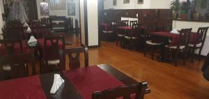 a dining room with red tables and chairs at Casa Frent in Predeal +11 photos