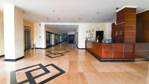 a large lobby with a bar in the middle of a building at N1 Hotel Tanah Abang in Jakarta