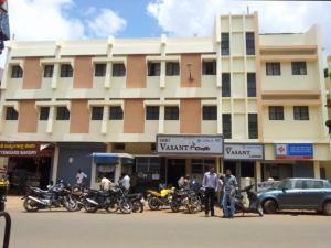 a group of motorcycles parked in front of a building at Shri Vasant Lodge in Hubli