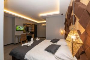 a bedroom with a large bed with a dog laying on it at Fly And Stay Airport Hotel in Istanbul