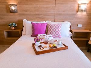 a tray of food sitting on top of a bed at Planet Dunas Residence in Aquiraz