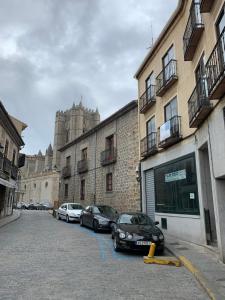 a group of cars parked in front of a building at Enjoy Ávila -LA CATEDRAL in Avila