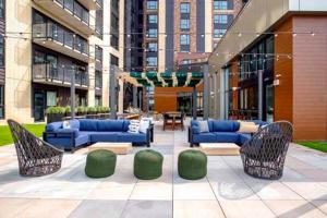 a patio with couches and chairs in a building at The Berkman in Rochester