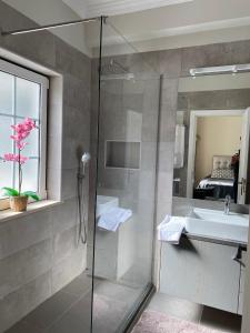 a bathroom with a glass shower and a sink at Charming Exceptional Golf Villa in Algarve in Faro