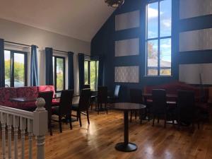 a living room with a couch and a table and chairs at Balreask Bar, Restaurant & Guest Accommodation in Navan