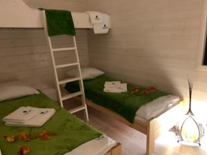 a room with two bunk beds and a ladder at Kantadaj Village Domki Prestige in Prudnik