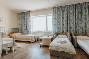 Postel nebo postele na pokoji v ubytování Staadioni Hotel