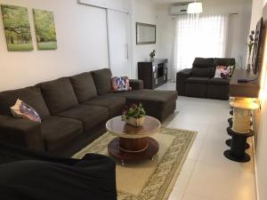 a living room with a couch and a table at Casa Walter in Balneário Camboriú