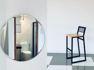 a mirror and a chair in a room at Loei Station in Loei