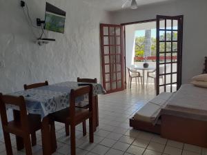 a living room with a table and a dining room at Residencial Hostal Blanco in Florianópolis
