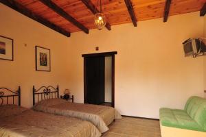 a bedroom with two beds and a tv and a couch at Guest House Orlinoe - Sevastopol in Orlinoye