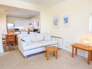 a living room with a white couch and a table at 4 Lyndhurst in Salcombe