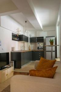 a living room with a couch and a kitchen at Hostel Denica in Skopje +35 photos