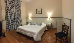 Postel nebo postele na pokoji v ubytování Hotel Ai Tufi