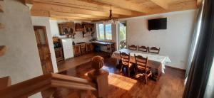 a kitchen and dining room with a table and chairs at PERFECT in Yaremche
