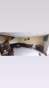 a room with tables and chairs and a ceiling at Stasio Balseviciaus Homestead in Raudonė