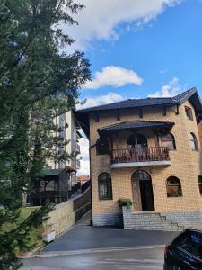 a building with a balcony on the side of it at Vila D&D in Zlatibor