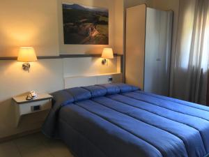 Postel nebo postele na pokoji v ubytování Hotel Ai Tufi