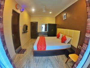 a bedroom with a bed with red pillows at new metro residency in Chennai