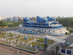 a large building with a fountain in front of it at Zeromiles Hotel Prasant in Digha