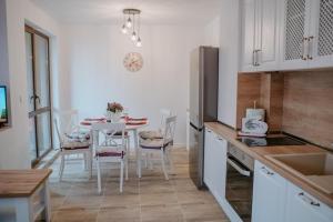 a kitchen with a table and chairs in a kitchen at Bella's Sea apartment-Beach, Sea garden ,Old Town, Free Parking, Free EVcharging Station in Varna City