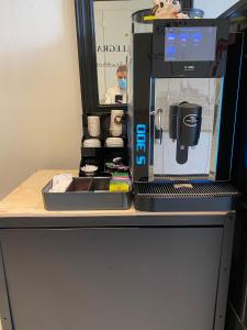 a coffee maker sitting on top of a desk at BALEGRA City Hotel Basel Contactless Self Check-in in Basel