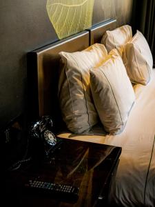a bed with pillows and a lamp on it at Figueira by The Beautique Hotels in Lisbon