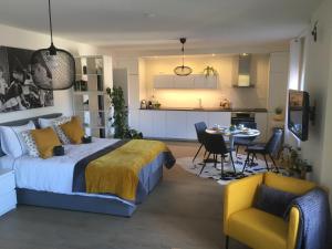 a bedroom with a bed and a table and chairs at Villa van Brienen - Studio in Dilsen-Stokkem