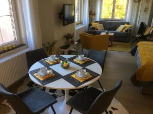 a living room with a table and chairs at Villa van Brienen - Studio in Dilsen-Stokkem