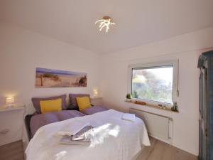 a bedroom with a bed and a window at Fewo Haus Bellevue - inkl. MeineCard+ in Willingen