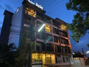 a building with a sign on top of it at P Bliss hotel in Phayao