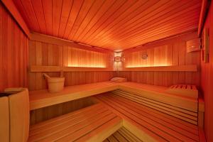 a sauna with wood paneling and lights in it at Kneipp-Kurhotel Steinle in Bad Wörishofen