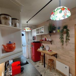 a kitchen with a red refrigerator and a table at NorbeHouse in Zamora