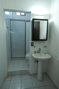 a bathroom with a shower and a sink and a toilet at Kinta Kan Cabañas Hotel Playa del Carmen in Playa del Carmen