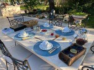 uma mesa com pratos azuis e tigelas de comida em Montaillon Chambres d'Hôtes em Mougon