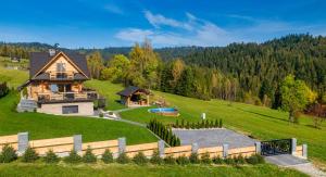 an aerial view of a house on a hill at Domek w górach DeLuxe sauna,jacuzzi,basen,hot tub-Nowy Targ blisko Białka ,Zakopane in Nowy Targ