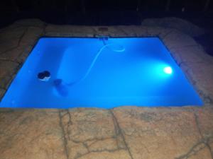 a swimming pool with a blue light in the dark at DaGama Dam - White River - Kestrel - House 21 in White River