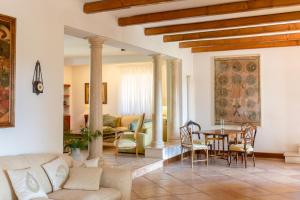 Villa Il Turchetto في ساتورنيا: غرفة معيشة مع طاولة وكراسي