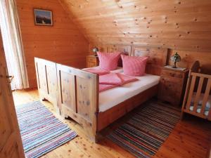 a bedroom with a bed in a log cabin at Ferienhaus "Zur alten Schmiede" in Mariahof