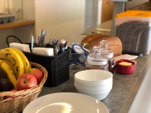 a kitchen counter with baskets of fruit and utensils at Lovell Camps - Mountain Lodge in Gstaad