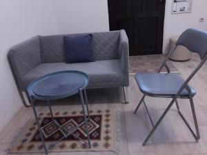 a living room with two chairs and a couch at Studio apartman Ela in Travnik
