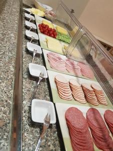 a row of meat and vegetables on a counter at Hotel Penterknapp in Bramsche