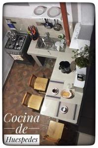a small kitchen with a stove and a sink at Casa Cultural Mindo in Mindo